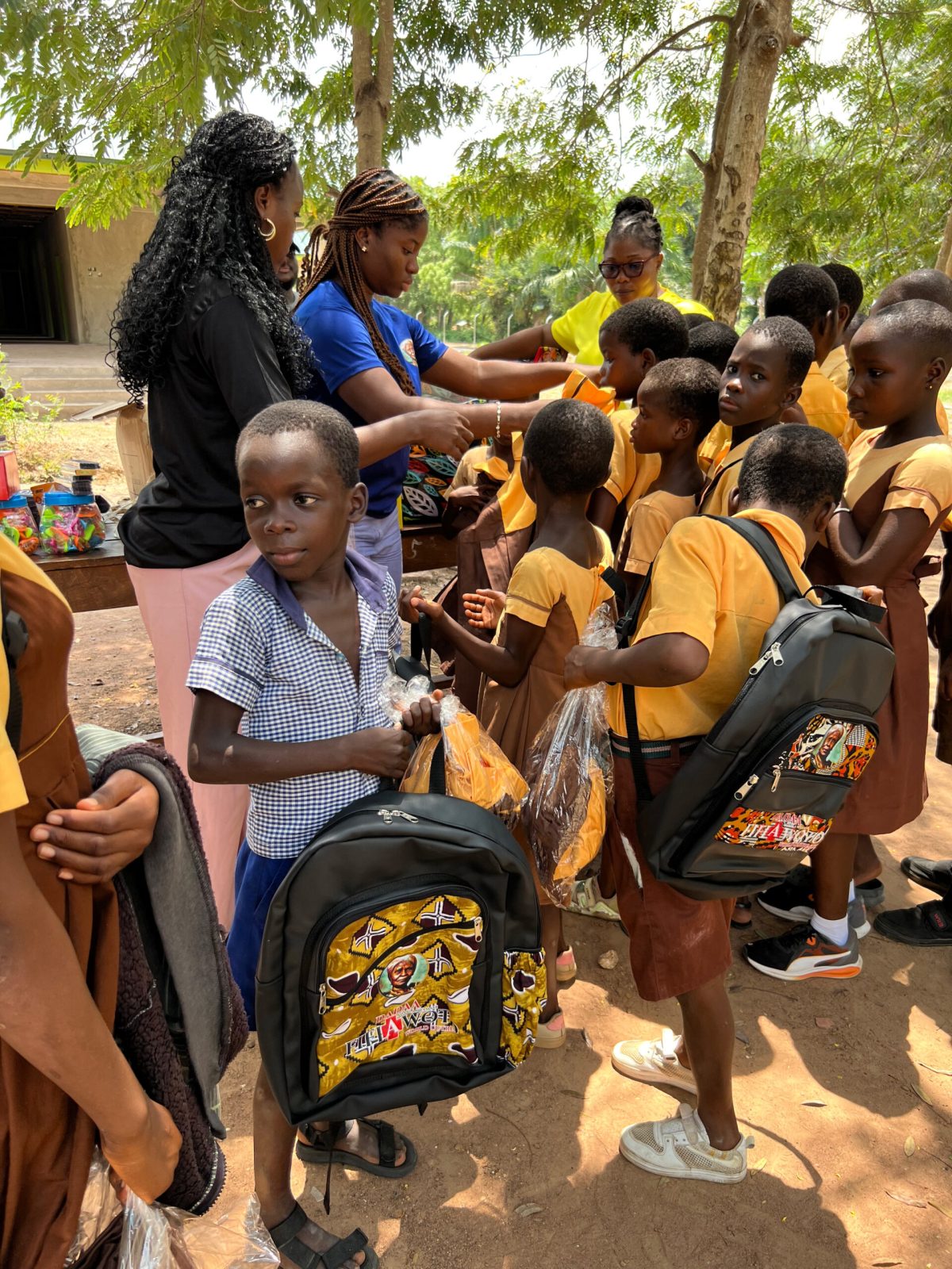 Foundation volunteers distributing school bags to children