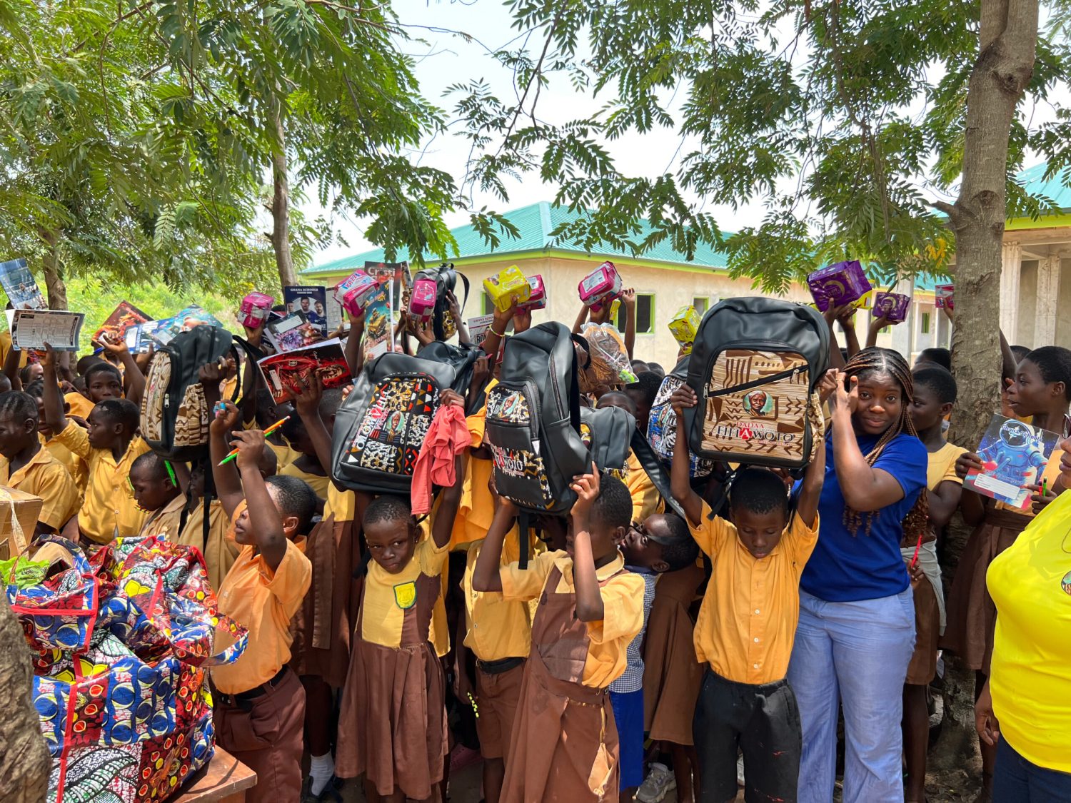 Children holding up new school bags donated through the foundation